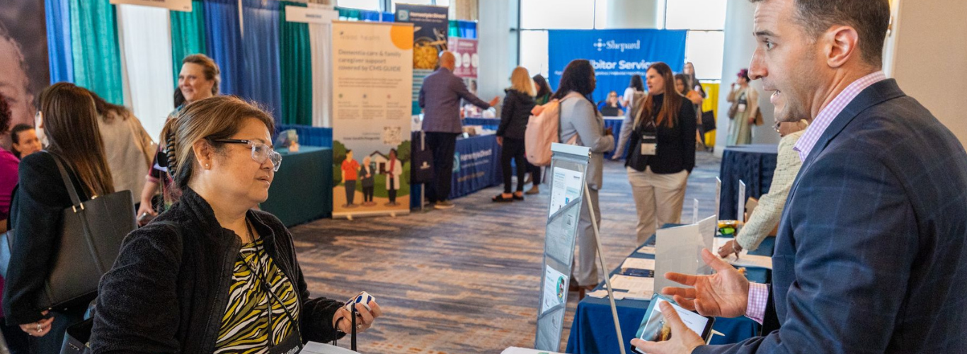 Man speaks to conference attendee