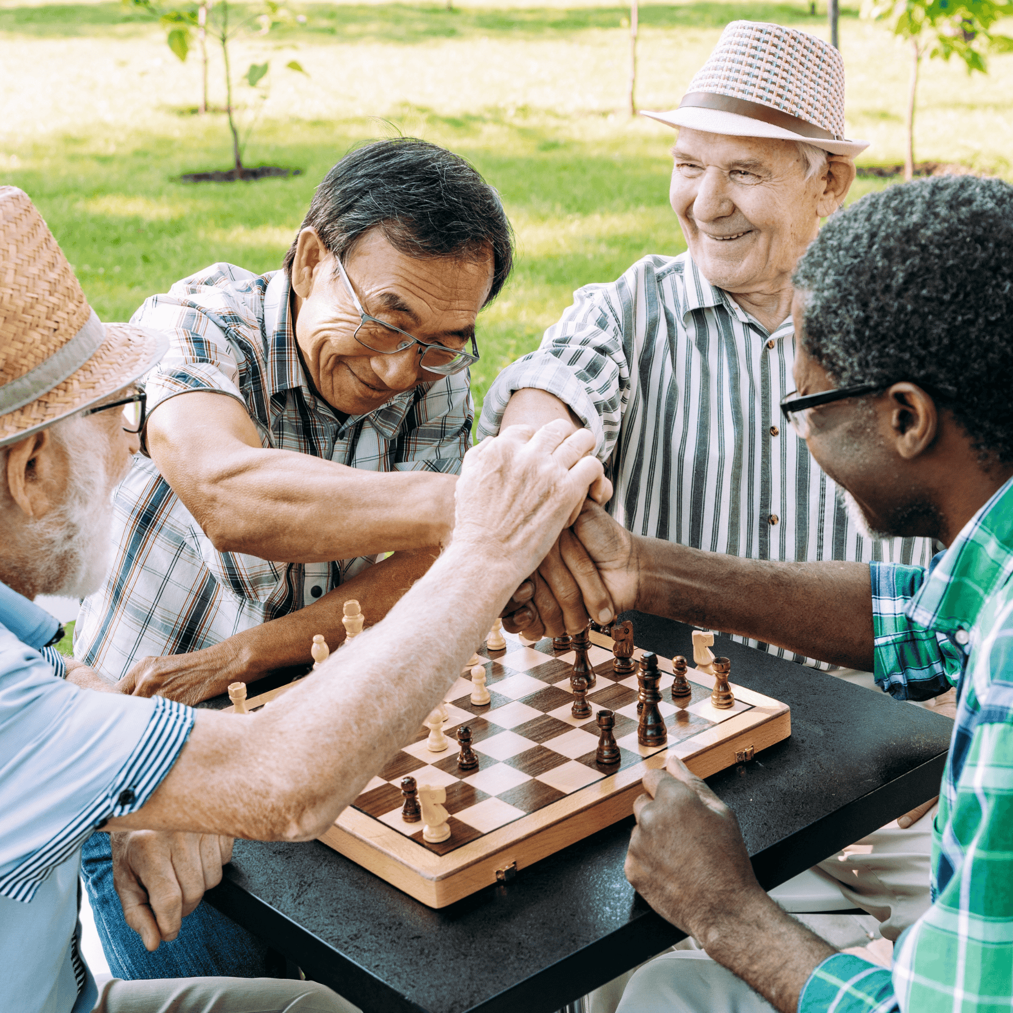 group of older men playing chess in a park